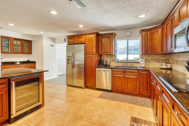 2605 Sunnybrook Dr, Sarasota, FL 34239 - kitchen featuring a sink, stainless steel appliances, wine cooler, backsplash, and visible vents