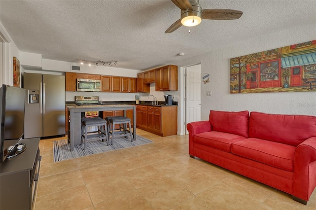 2605 Sunnybrook Dr, Sarasota, FL 34239 - living room with a ceiling fan, a textured ceiling, visible vents, and track lighting