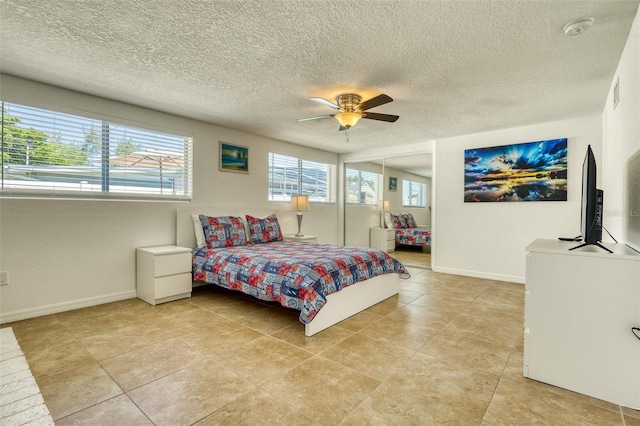 2605 Sunnybrook Dr, Sarasota, FL 34239 - bedroom featuring a ceiling fan, a textured ceiling, visible vents, light tile patterned floors, and baseboards