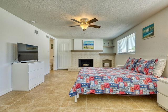 2605 Sunnybrook Dr, Sarasota, FL 34239 - bedroom with a brick fireplace, a ceiling fan, a textured ceiling, and visible vents