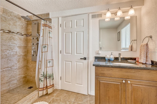2605 Sunnybrook Dr, Sarasota, FL 34239 - full bath with vanity, tile patterned flooring, a tile shower, and a textured ceiling