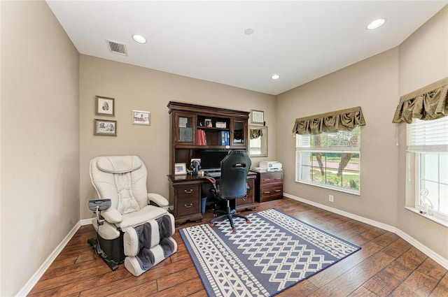 office featuring hardwood / wood-style floors, visible vents, and baseboards