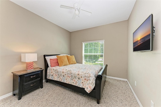 bedroom featuring light carpet, baseboards, and ceiling fan