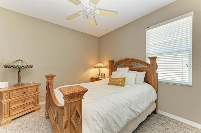 bedroom featuring light carpet, baseboards, and a ceiling fan