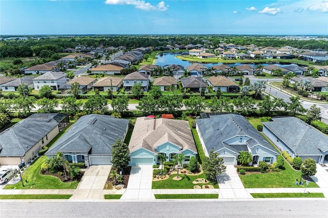 bird's eye view featuring a residential view and a water view