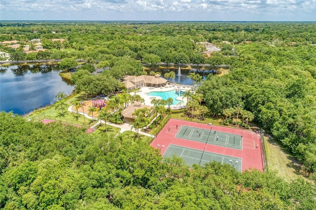 drone / aerial view featuring a water view and a wooded view