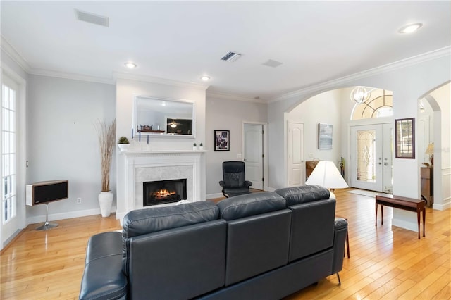 1860 Citron St, Punta Gorda, FL 33980 - living room featuring arched walkways, light wood finished floors, visible vents, and crown molding