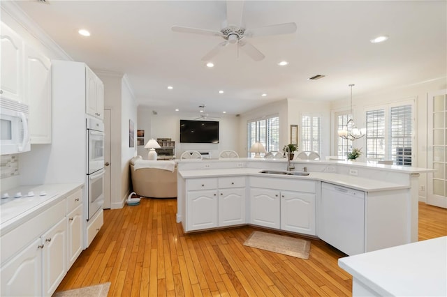 1860 Citron St, Punta Gorda, FL 33980 - kitchen with white appliances, light wood-style flooring, a ceiling fan, a sink, and open floor plan