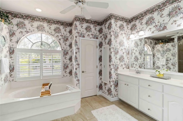 1860 Citron St, Punta Gorda, FL 33980 - full bath with vanity, a garden tub, wallpapered walls, and ceiling fan