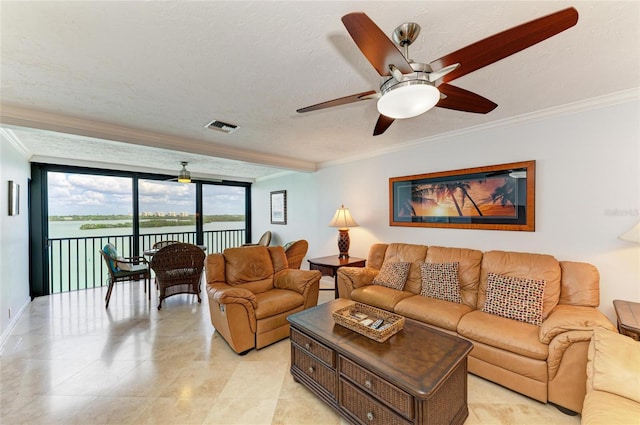 living area featuring visible vents, crown molding, ceiling fan, and a textured ceiling