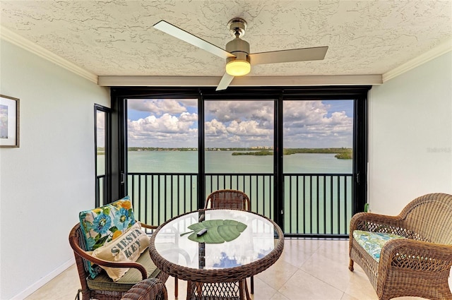 sunroom with a wealth of natural light and a water view