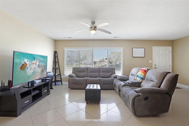 living room featuring baseboards, visible vents, and a ceiling fan