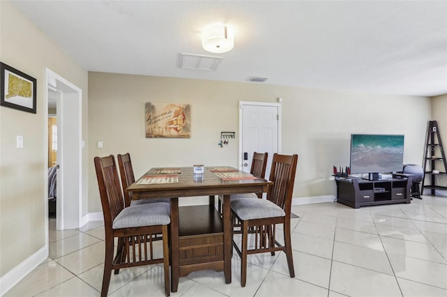 dining space with light tile patterned floors, baseboards, and visible vents
