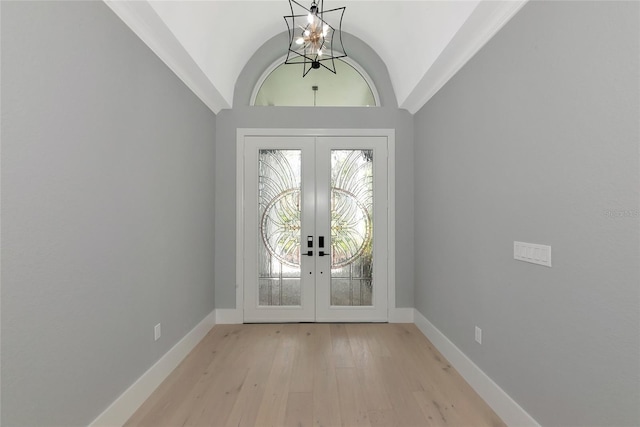 600 Eagle Watch Ln, Osprey, FL 34229 - entryway with french doors, a chandelier, light wood-type flooring, and vaulted ceiling