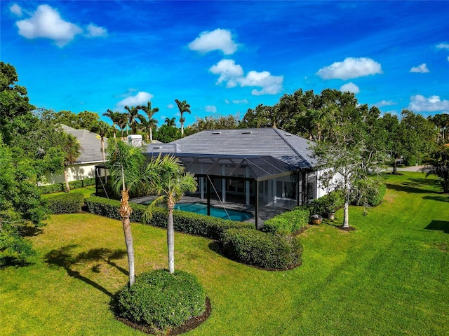 600 Eagle Watch Ln, Osprey, FL 34229 - back of property with a yard, an outdoor pool, glass enclosure, and a patio