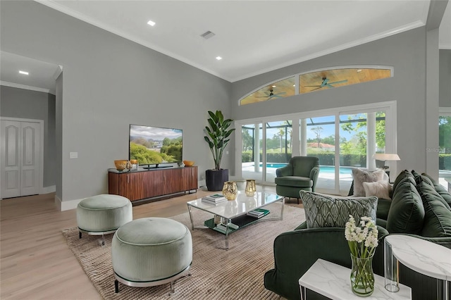 600 Eagle Watch Ln, Osprey, FL 34229 - living room with ceiling fan, light wood-style flooring, recessed lighting, a towering ceiling, and ornamental molding