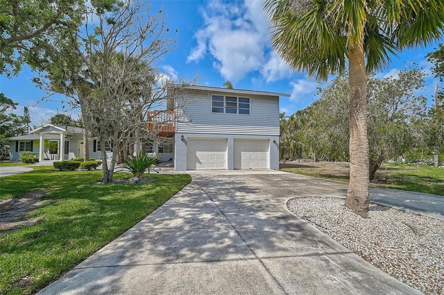 view of front of house with driveway, a front lawn, and a garage
