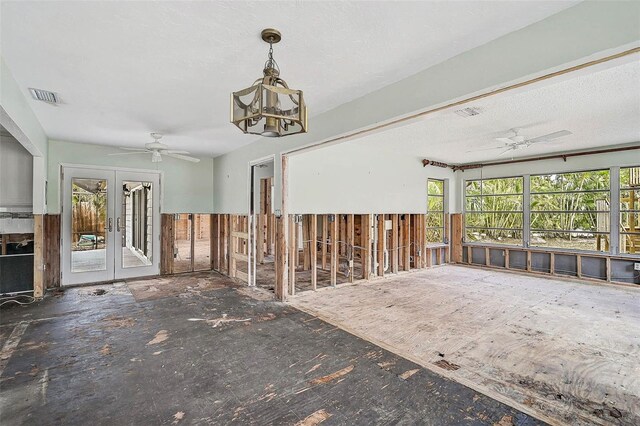 misc room with french doors, a ceiling fan, and a chandelier