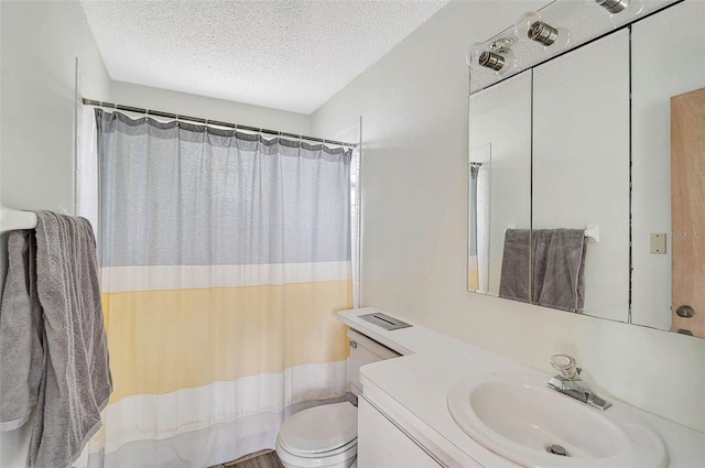 bathroom featuring a textured ceiling, toilet, vanity, and a shower with curtain