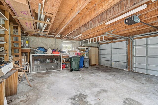 garage featuring a garage door opener and electric water heater