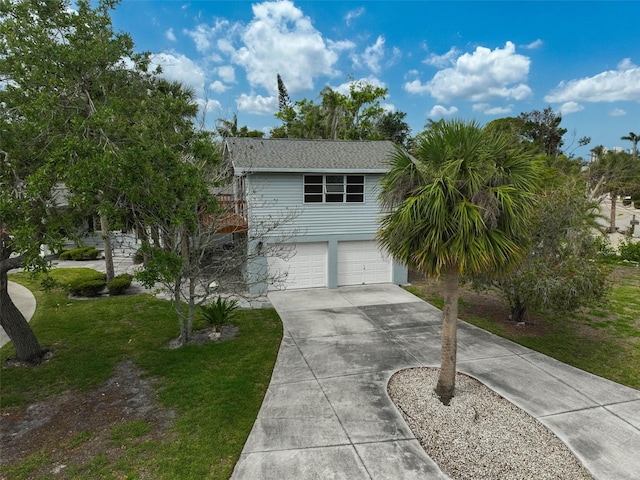 view of front of house with driveway, a garage, and a front lawn