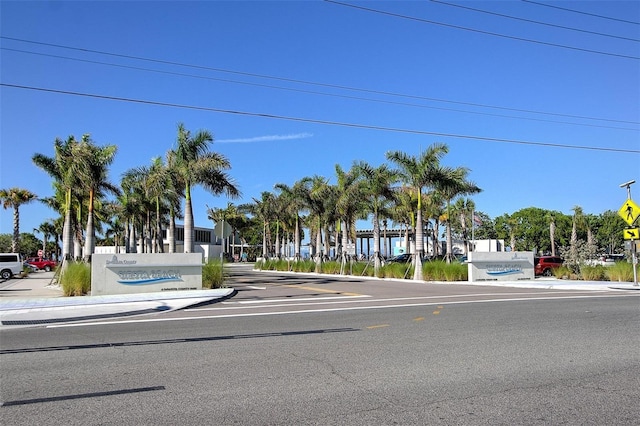 view of asphalt street with sidewalks, traffic signs, and curbs
