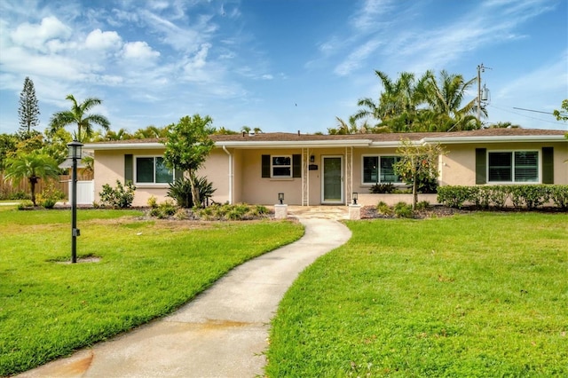 single story home with a front yard and stucco siding