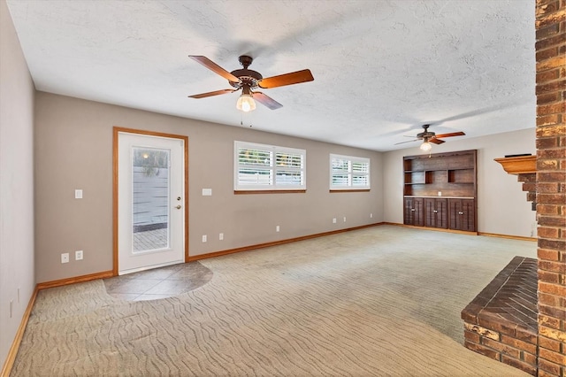 unfurnished living room featuring a textured ceiling, baseboards, a ceiling fan, and carpet floors