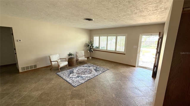 3072 Meyer Dr, Sarasota, FL 34239 - living area with a textured ceiling and baseboards