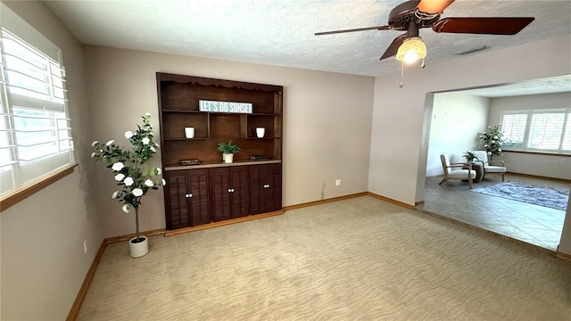 3072 Meyer Dr, Sarasota, FL 34239 - spare room featuring a ceiling fan, baseboards, light carpet, and a textured ceiling