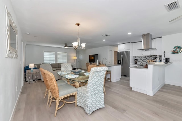 8152 Seashell St, Englewood, FL 34224 - dining space featuring light wood-style floors, baseboards, ceiling fan, a chandelier, and recessed lighting