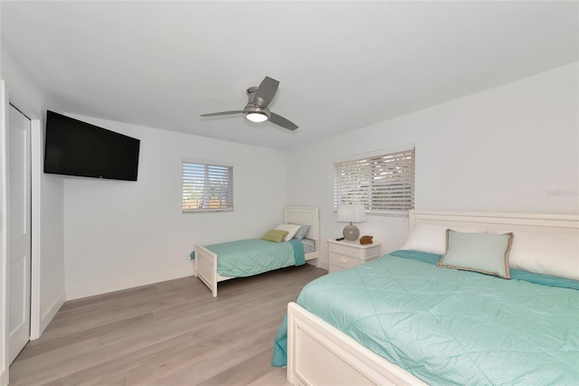 8152 Seashell St, Englewood, FL 34224 - bedroom featuring light wood-type flooring, a ceiling fan, and baseboards