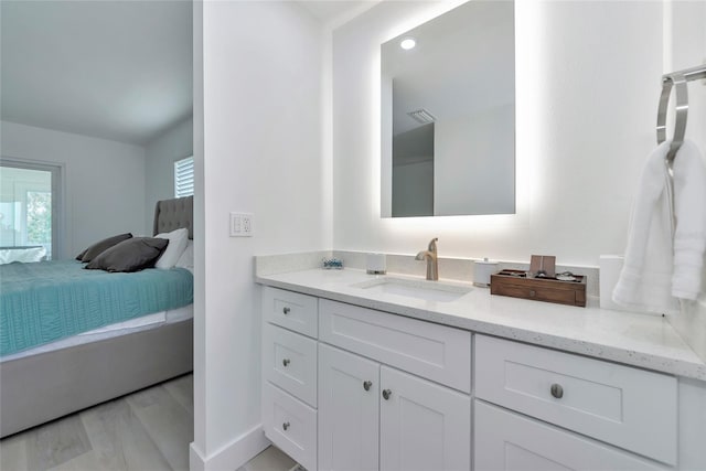 8152 Seashell St, Englewood, FL 34224 - bathroom featuring ensuite bath, vanity, and wood finished floors