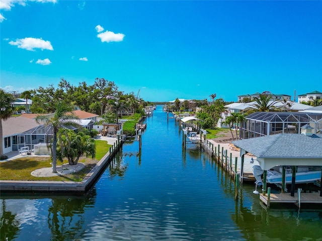 8152 Seashell St, Englewood, FL 34224 - dock area with boat lift, a water view, a residential view, and a yard