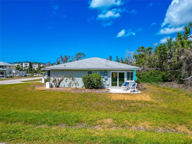 8152 Seashell St, Englewood, FL 34224 - back of property with a yard and stucco siding
