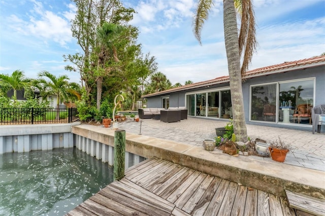back of property with stucco siding, an outdoor hangout area, a fenced backyard, and a patio area
