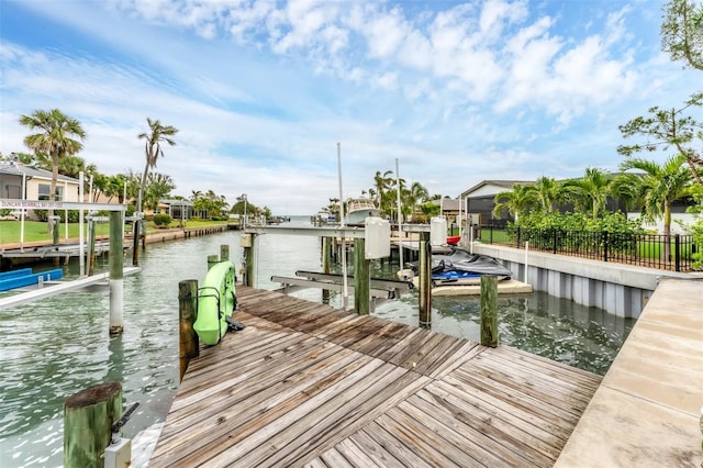 dock area with boat lift and a water view