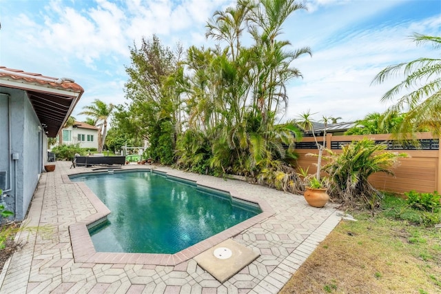 pool featuring a patio area and fence