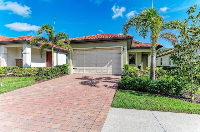 224 Soliera St, Nokomis, FL 34275 - mediterranean / spanish-style home featuring a tile roof, a garage, decorative driveway, and stucco siding