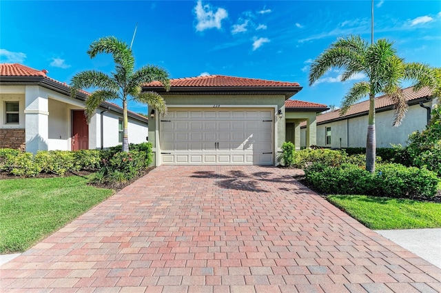 224 Soliera St, Nokomis, FL 34275 - mediterranean / spanish house featuring a garage, stucco siding, a tile roof, and decorative driveway