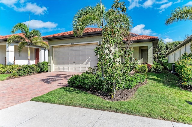 224 Soliera St, Nokomis, FL 34275 - mediterranean / spanish home with stucco siding, decorative driveway, a front lawn, a tile roof, and an attached garage