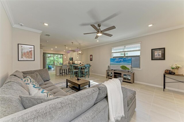 224 Soliera St, Nokomis, FL 34275 - living room with ornamental molding, ceiling fan, and a healthy amount of sunlight