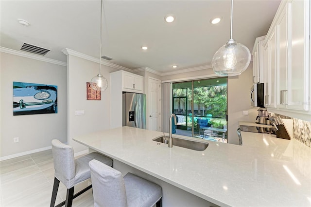 224 Soliera St, Nokomis, FL 34275 - kitchen featuring visible vents, a sink, a peninsula, crown molding, and stainless steel appliances