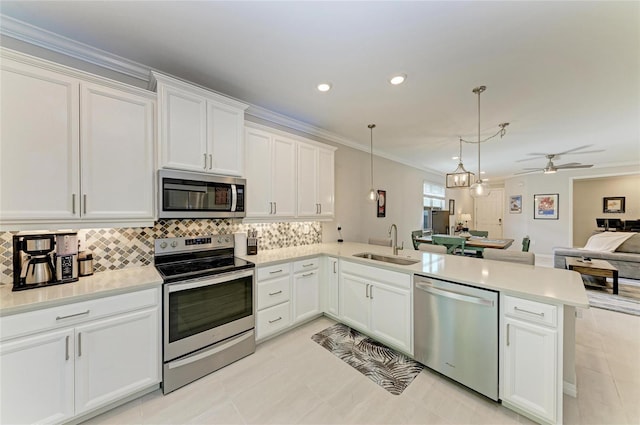 224 Soliera St, Nokomis, FL 34275 - kitchen featuring appliances with stainless steel finishes, open floor plan, a peninsula, ceiling fan, and a sink
