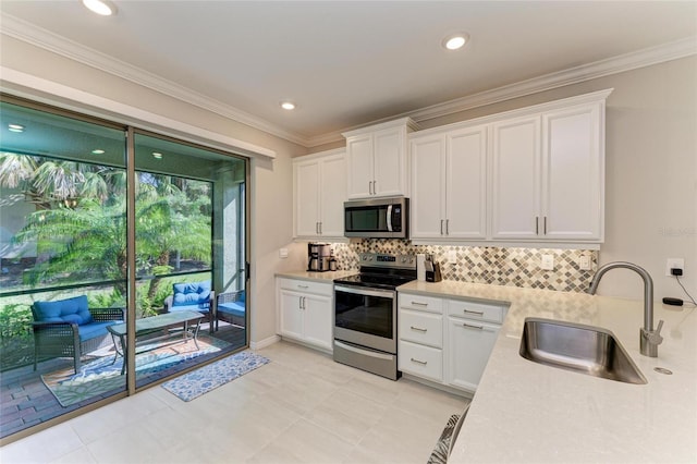 224 Soliera St, Nokomis, FL 34275 - kitchen featuring light countertops, backsplash, white cabinetry, appliances with stainless steel finishes, and a sink