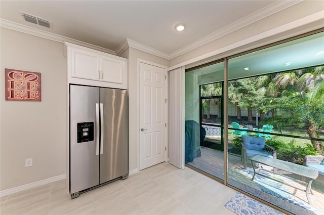 224 Soliera St, Nokomis, FL 34275 - kitchen with crown molding, white cabinetry, visible vents, stainless steel fridge, and baseboards
