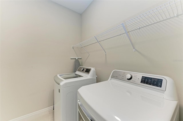 224 Soliera St, Nokomis, FL 34275 - clothes washing area with baseboards, washing machine and dryer, and laundry area