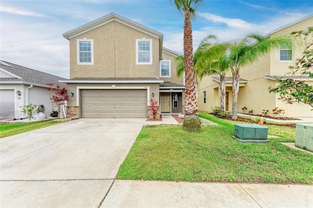 1912 Hawks View Dr, Ruskin, FL 33570 - traditional home featuring concrete driveway, a front yard, an attached garage, and stucco siding