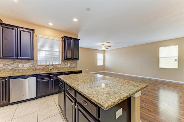 1912 Hawks View Dr, Ruskin, FL 33570 - kitchen with ceiling fan, stainless steel dishwasher, a sink, open floor plan, and decorative backsplash