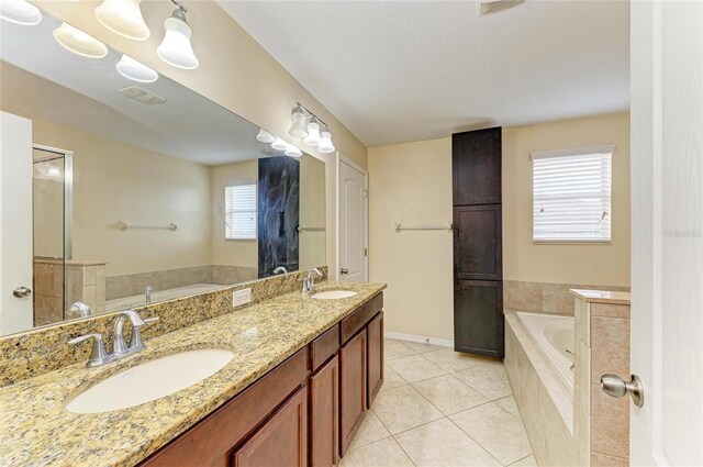 1912 Hawks View Dr, Ruskin, FL 33570 - bathroom featuring tile patterned floors, a garden tub, and a sink
